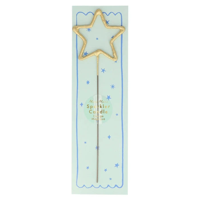 Gold star-shaped sparkler candle on a light green card with blue stars