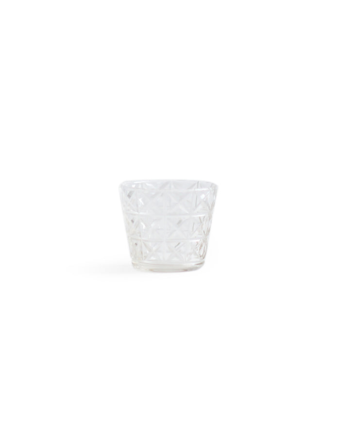 Silhouetted mini choko cut glass in crystal pattern against white background.