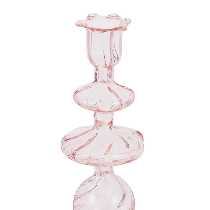 Pink glass candlestick with swirled, rounded tiers and a fluted top edge.