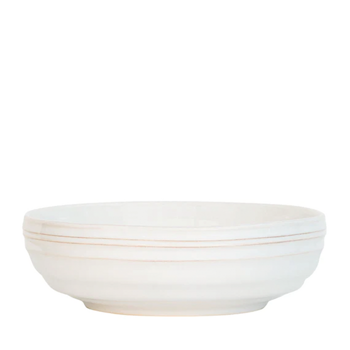 A white ceramic stoneware bowl with a simple design and a slight lip on the edge.