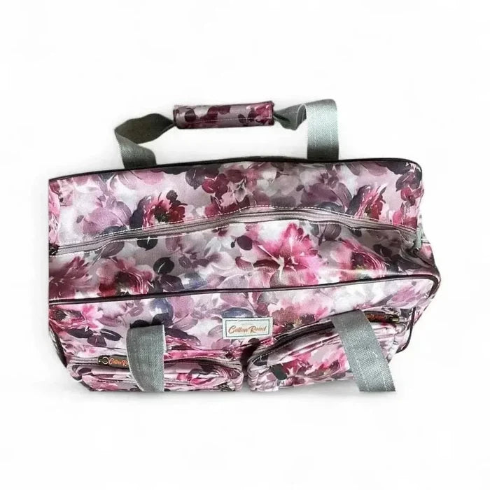 Light pink Cotton Road travel bag with purple roses and adjustable strap