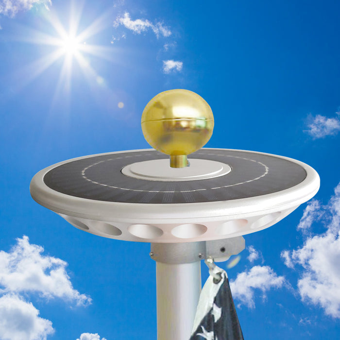 Solar flagpole top light illuminating American flag at night