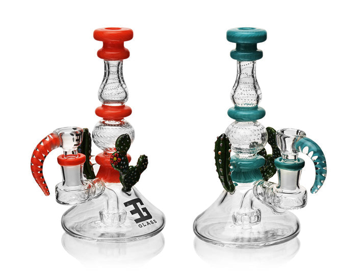 Two glass smoking accessories with red and green accents on a white background