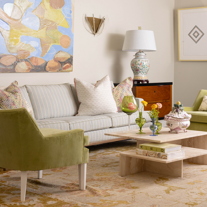 Cream square decorative pillow with delicate fern leaf pattern on light fabric, 22-inch size.
