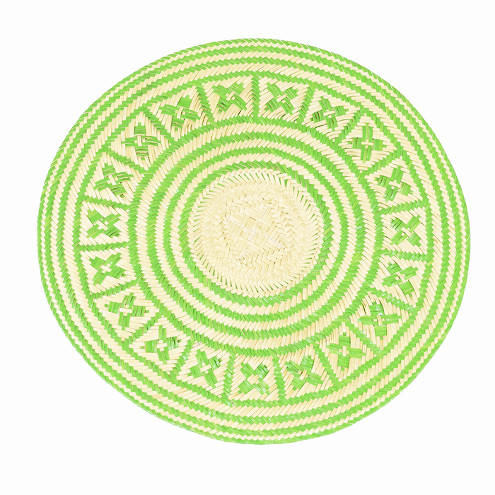 A round placemat with a geometric pattern primarily in green color, displayed on a white background.