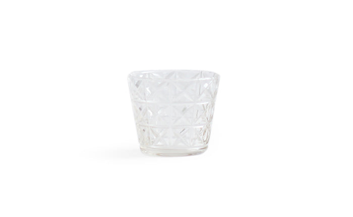 Silhouetted mini choko cut glass in crystal pattern against white background.