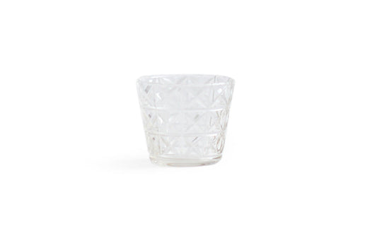 Silhouetted mini choko cut glass in crystal pattern against white background.