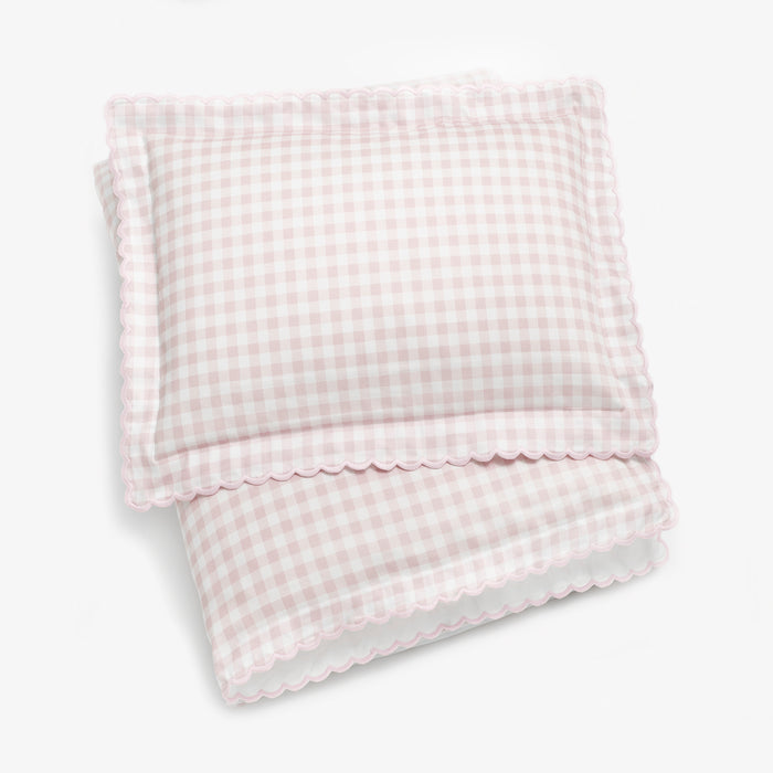 Toddler duvet folded with toddler pillow on top in the Picnic Gingham in the color pink