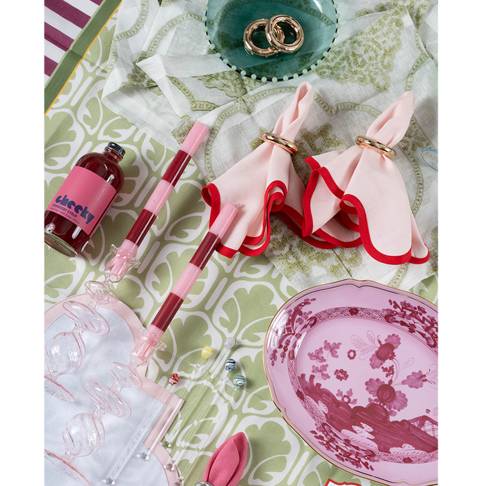 Pink glass candlestick with a swirl pattern, slender and elegant design.