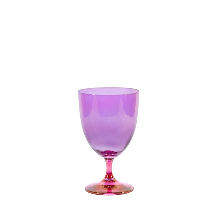 A purple and pink ombre water glass with a smooth exterior and a playful pop of color.