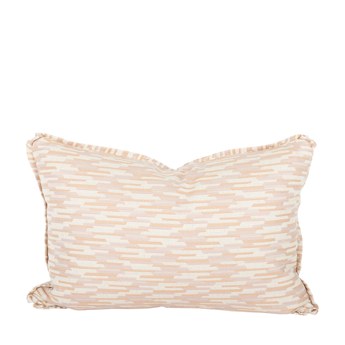 A square-shaped lumbar pillow with a geometric pattern in peach hues.