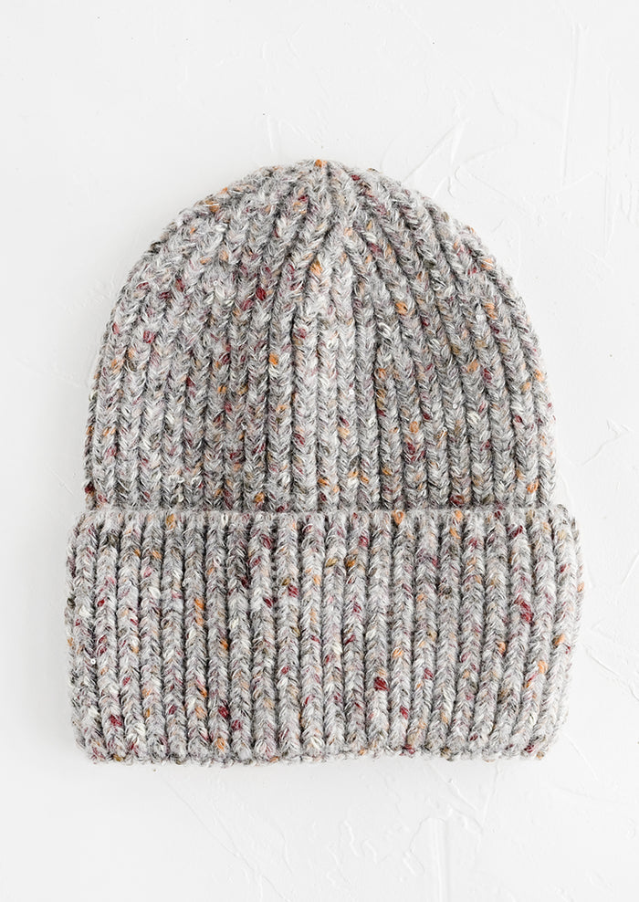 A knit beanie hat with cuffed rim made in speckled heather grey yarn.