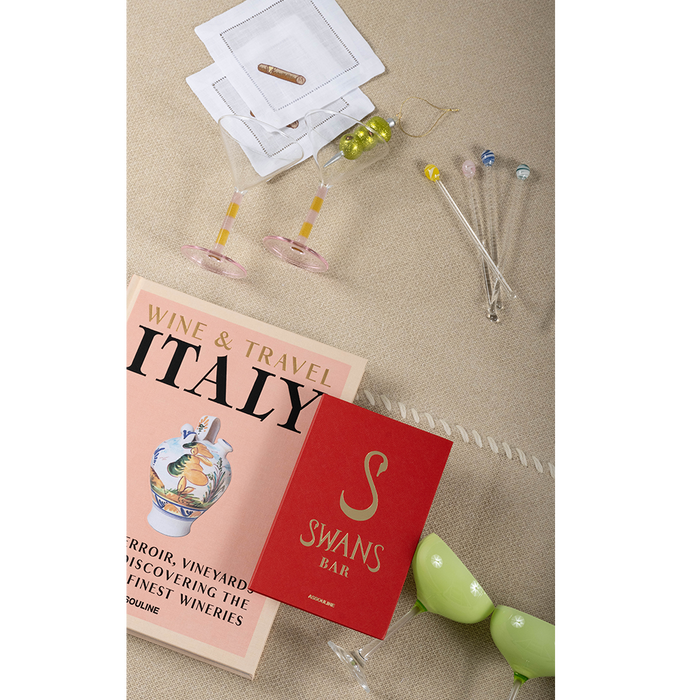 Set of eight silver metal cocktail swizzle sticks with colorful round bead tops in yellow, blue, and clear.